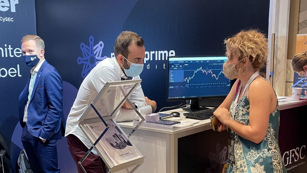 A photo from iFX Expo Dubai 2021 showing people talking at the booth of the Match-Prime regulated liquidity provider